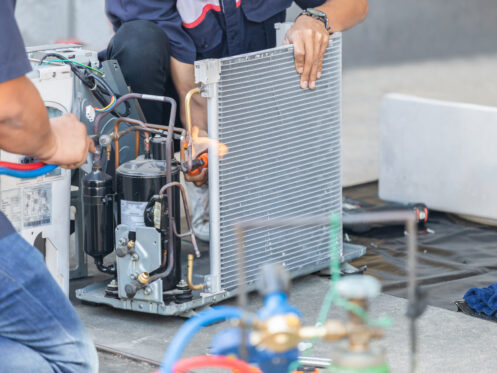 A team of AC techs working on an AC