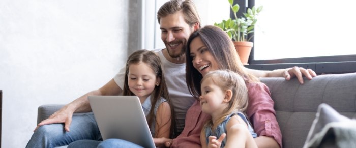cute family looking at laptop